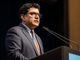 Jaime Lizárraga speaking at a conference podium.