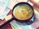 Illustration of cryptocurrency under investigation for fraud with legal documents and a magnifying glass.