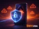 Crypto security illustration showing a shield and warning symbols, representing scam prevention and protection in the crypto space.